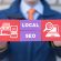 Man holding sign reading "Local SEO." Improve your local SEO with enhanced business listings.